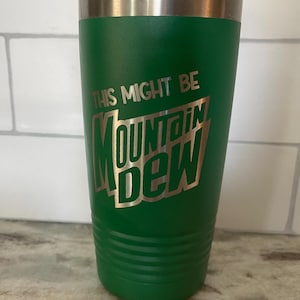 May include: Green stainless steel tumbler with a silver lid. The tumbler has a white inscription that reads "This might be Mountain Dew".