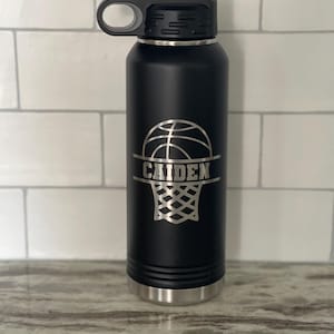 May include: Black stainless steel water bottle with a basketball and net design and the name "CAIDEN" engraved on it.