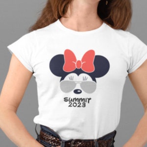 May include: White t-shirt with a cartoon image of Minnie Mouse wearing sunglasses and a red bow. The text "Summit 2023" is printed below the image.