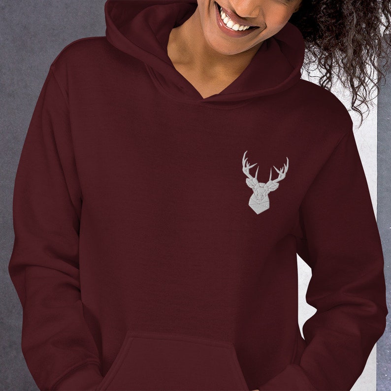 May include: A maroon hoodie with a white embroidered deer head design on the front.