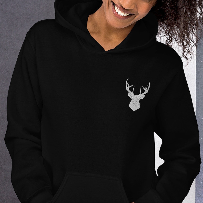 May include: Black hooded sweatshirt with a silver geometric deer design on the front.
