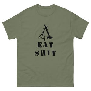 May include: Olive green t-shirt with a black graphic of a mortar and the words "EAT SHIT" in a bold, distressed font. The shirt is made of a soft, comfortable material.