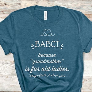 May include: A teal blue t-shirt with white text that reads "BABCI because "grandmother" is for old ladies."