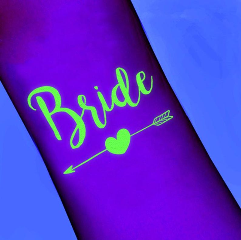 May include: A purple surface with the word "Bride" in bright green script. A green heart and arrow design is below the word, pointing to the right. The background is a gradient of purple and blue.