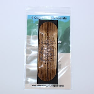 May include: A wooden fingerboard with a black background and the text "4 Corner Fingerboards" and "etsy.com/shop/4CFingerboards".
