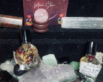 Roll-ons de aceites esenciales, frascos con forma de calavera, hierbas y cristales.