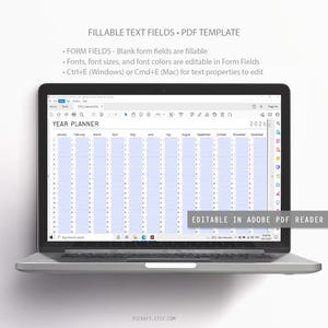 May include: A laptop displaying a 2026 year planner template. The screen shows a grid with months and dates, designed for fillable text fields. Text on the screen includes "YEAR PLANNER" and "EDITABLE IN ADOBE PDF READER".