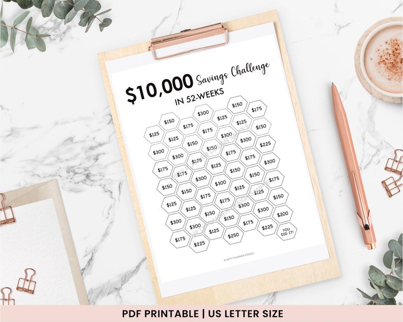 May include: A printable savings challenge chart with a honeycomb design. The chart is titled "$10,000 Savings Challenge in 52 Weeks". Each hexagon contains a dollar amount, starting with $125 and increasing to $300.