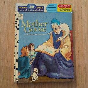 May include: A Mother Goose nursery rhyme talking book with a blue cover featuring an illustration of an elderly person reading to two children and a goose. The top includes a built-in speaker and text stating, I talk using my built-in speaker.