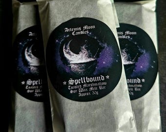May include: Three rectangular wax melt bars in clear plastic packaging. Each features a circular label with a crescent moon and cauldron graphic, text reading Artemis Moon Candles, Spellbound, Toasted Marshmallow Soy Wax Melt Bar, Approx 30g.