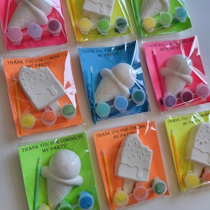 May include: Eight individual party favor bags, each containing a white ceramic ice cream cone or popsicle, paint pots, and a paintbrush. The bags are labeled with the text "Thank you for coming to my party!"