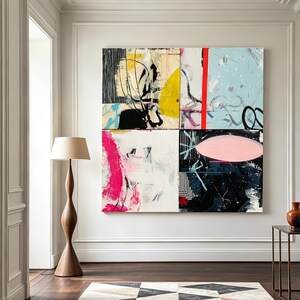 May include: An abstract artwork composed of six panels, featuring a mix of colors including yellow, pink, black, and blue. The artwork is mounted on a white wall in a room with a wooden floor, a patterned rug, and a wooden floor lamp.