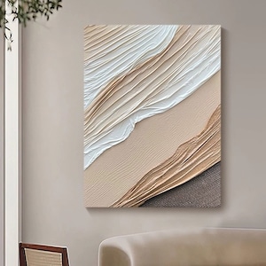 May include: Abstract art print with a textured, layered design in shades of white, beige, and brown. The print features a wave-like pattern and a subtle, textured background.