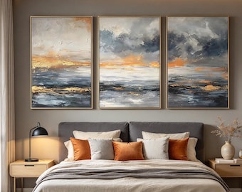 May include: A triptych wall art set featuring three rectangular canvases with abstract landscape paintings. The artwork displays a textured blend of dark navy blue, charcoal gray, white, and metallic gold paint strokes depicting a stormy horizon.