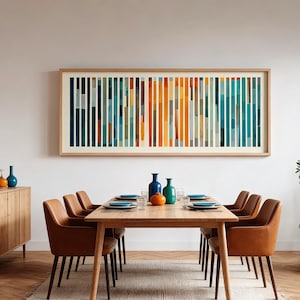 May include: A dining room setup with a wooden table and six brown leather chairs. A large framed abstract artwork with vertical stripes in blue, orange, and green hangs above. The table is set with plates, glasses, and decorative vases, creating a modern aesthetic.