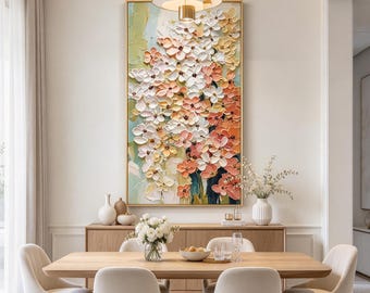 May include: A large rectangular wall art piece featuring a thick, textured impasto painting of layered flowers in shades of white, peach, and soft orange. The artwork is framed in gold and displays a dense floral arrangement with visible brushstrokes.