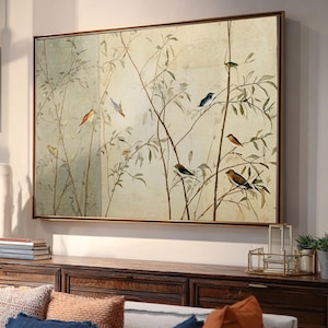 May include: A framed print depicting birds on branches in a vintage style. The artwork uses a neutral palette of beige, green, and brown. It is presented within a dark brown wooden frame, suitable for home decor.