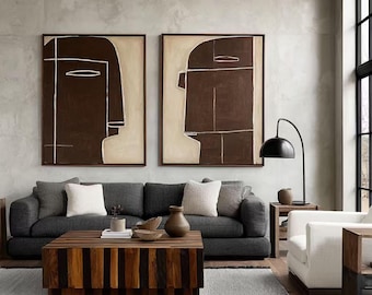 May include: Two rectangular wall art pieces featuring abstract dark brown human profiles on a light beige background, framed in thin dark wood. The artwork displays simple white line details outlining the facial features and head shapes.