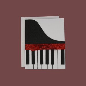 Biglietto d'auguri per pianoforte con fiocco glitterato