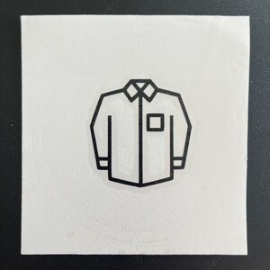 May include: A black and white line drawing of a long-sleeved shirt with a pocket on the left side.