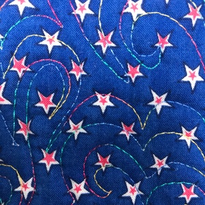 May include: Blue fabric with a white and red star pattern. The stars are connected by colorful, wavy lines.