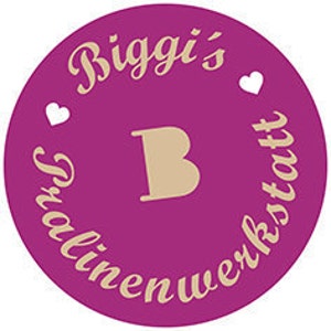 May include: A circular, magenta-colored logo with the text "Biggi's" in a cursive font at the top, and "Textilienwerkstatt" in a similar font around the bottom. A large, tan letter "B" is in the center, with two small white hearts on either side of "Biggi's".