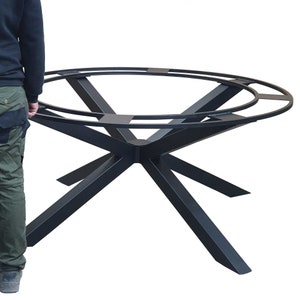 May include: Black metal table base with a star-shaped design and a double ring top. The base is made of sturdy metal and has a black finish.