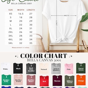Puede incluir: Una camiseta blanca en una percha de madera, con una tabla de tallas y una carta de colores. La tabla de tallas muestra medidas en pulgadas para las tallas XS a 5XL. La carta de colores muestra varios colores de camisetas, incluyendo blanco, negro y rosa.