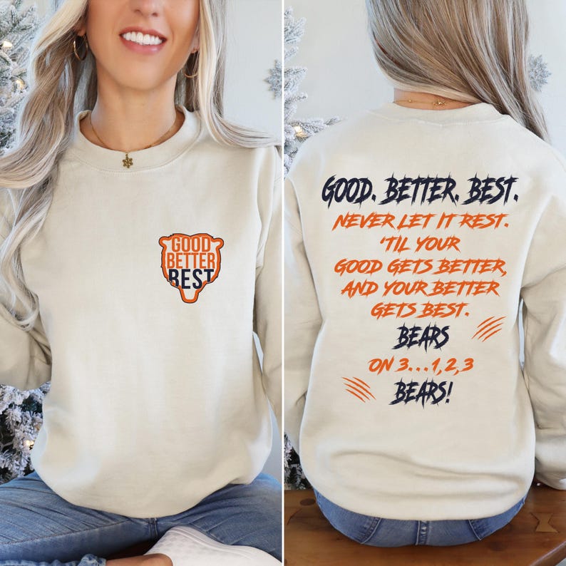 May include: Cream-coloured sweatshirt. The front features the text "GOOD BETTER REST" in a shield design. The back displays the text "GOOD. BETTER. BEST. NEVER LET IT REST... BEARS ON 3...1,2,3 BEARS!" in navy and orange.