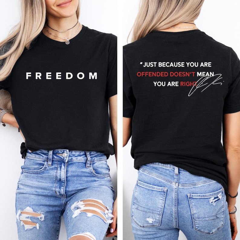 May include: Black t-shirt with the word "FREEDOM" in white block letters on the front. The back of the shirt has the quote, "JUST BECAUSE YOU ARE OFFENDED DOESN'T MEAN YOU ARE RIGHT" in white and red.