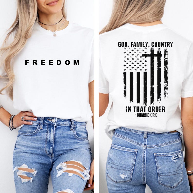 May include: White t-shirt with the word "FREEDOM" printed in black on the front. The back of the shirt features an American flag design with a cross and the text "GOD, FAMILY, COUNTRY IN THAT ORDER - CHARLIE KIRK."