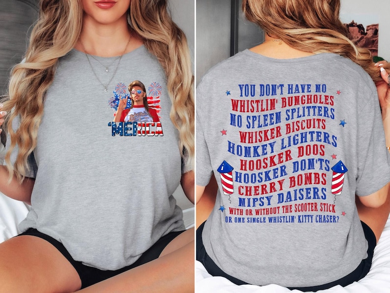 Pode incluir: Camiseta cinza claro com um design patri&oacute;tico. A frente apresenta uma pessoa com &oacute;culos de sol e a palavra "MERICA". A parte de tr&aacute;s mostra texto patri&oacute;tico e fogos de artif&iacute;cio.