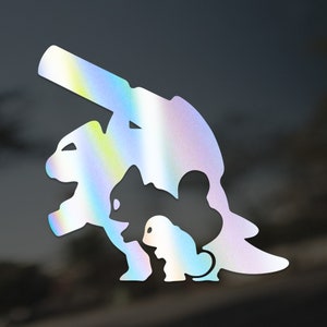 May include: A holographic vinyl sticker featuring a silhouette of three dinosaurs, a large one with a long neck, a medium-sized one with a long tail, and a small one with a round body.