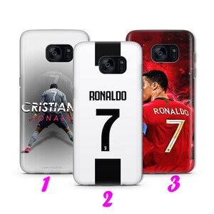 May include: Three different phone cases featuring Cristiano Ronaldo. The first case is gray with a photo of Ronaldo playing soccer. The second case is white with a black stripe down the middle and the number 7. The third case is red with a photo of Ronaldo in a red jersey with the number 7.