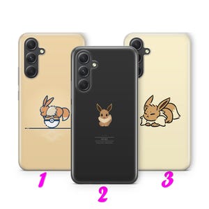 May include: Three phone cases with Eevee designs. The cases are light tan and black. One case features Eevee in a Poké Ball, another shows Eevee standing, and the third has Eevee sleeping. The cases have a glossy finish.