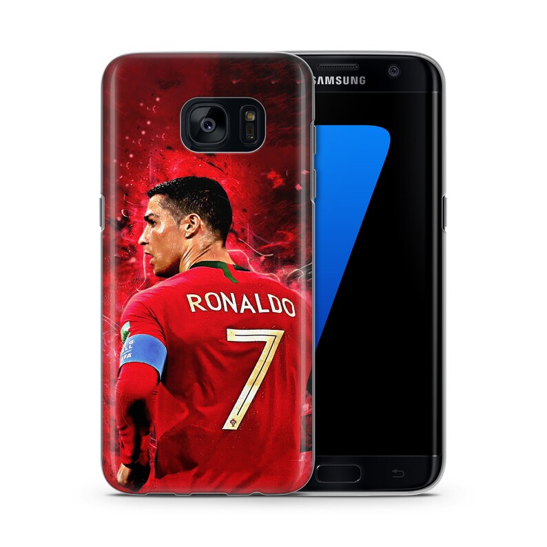 May include: A red, white, and gold phone case with a picture of Cristiano Ronaldo wearing a red soccer jersey with the number 7 on the back. The text "RONALDO" is printed above the number. The case is designed for a Samsung Galaxy S7 Edge.