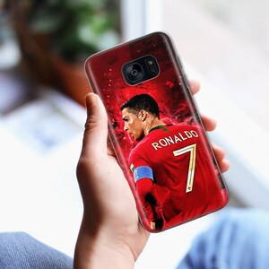 May include: A red, white, and green phone case with a picture of a soccer player wearing a red jersey with the number 7 and the name "RONALDO" on the back.
