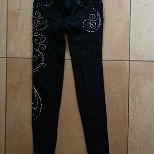 Black cotton jeggings/pants with silver bedazzled detailing. Looks amazing on stage!