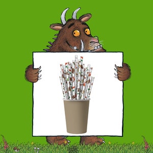 May include: A brown monster with a big smile holds up a white sign with a brown paper cup filled with colorful striped paper straws. The straws have a pattern of small animals and plants.