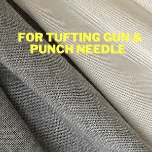 Może przedstawiać: Dwa kawałki tkaniny, jeden jasnoszary, a drugi ciemnoszary, z nadrukiem "FOR TUFTING GUN & PUNCH NEEDLE" w kolorze żółtym.