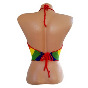 May include: A rainbow crochet halter top with red ties in the back.