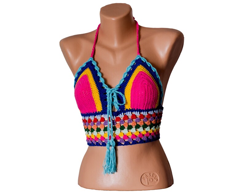 May include: A colorful crocheted halter top with a blue, pink, yellow, and green color scheme. The top has a tassel detail and a tie closure at the neck.