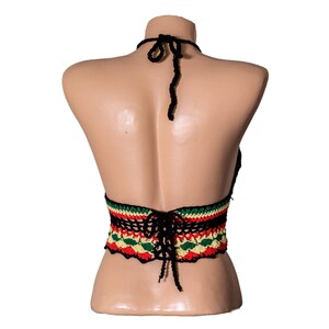 May include: Black crochet halter top with a colorful striped band around the waist. The band features red, yellow, and green stripes.