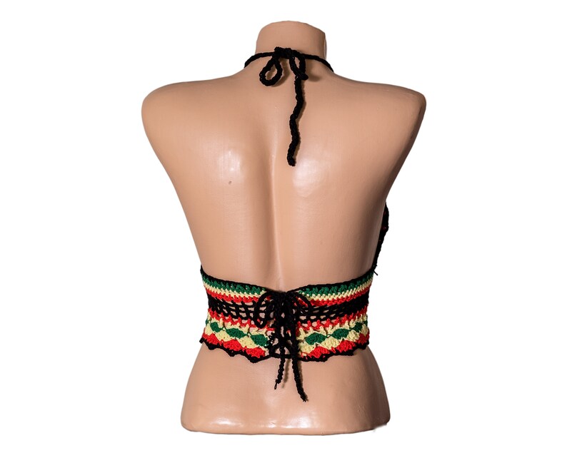May include: Black crochet halter top with a colorful striped band around the waist. The band features red, yellow, and green stripes.