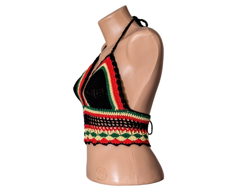 May include: A black crochet halter top with red, green, and yellow stripes. The top has a crocheted design and is made of a soft, lightweight material.