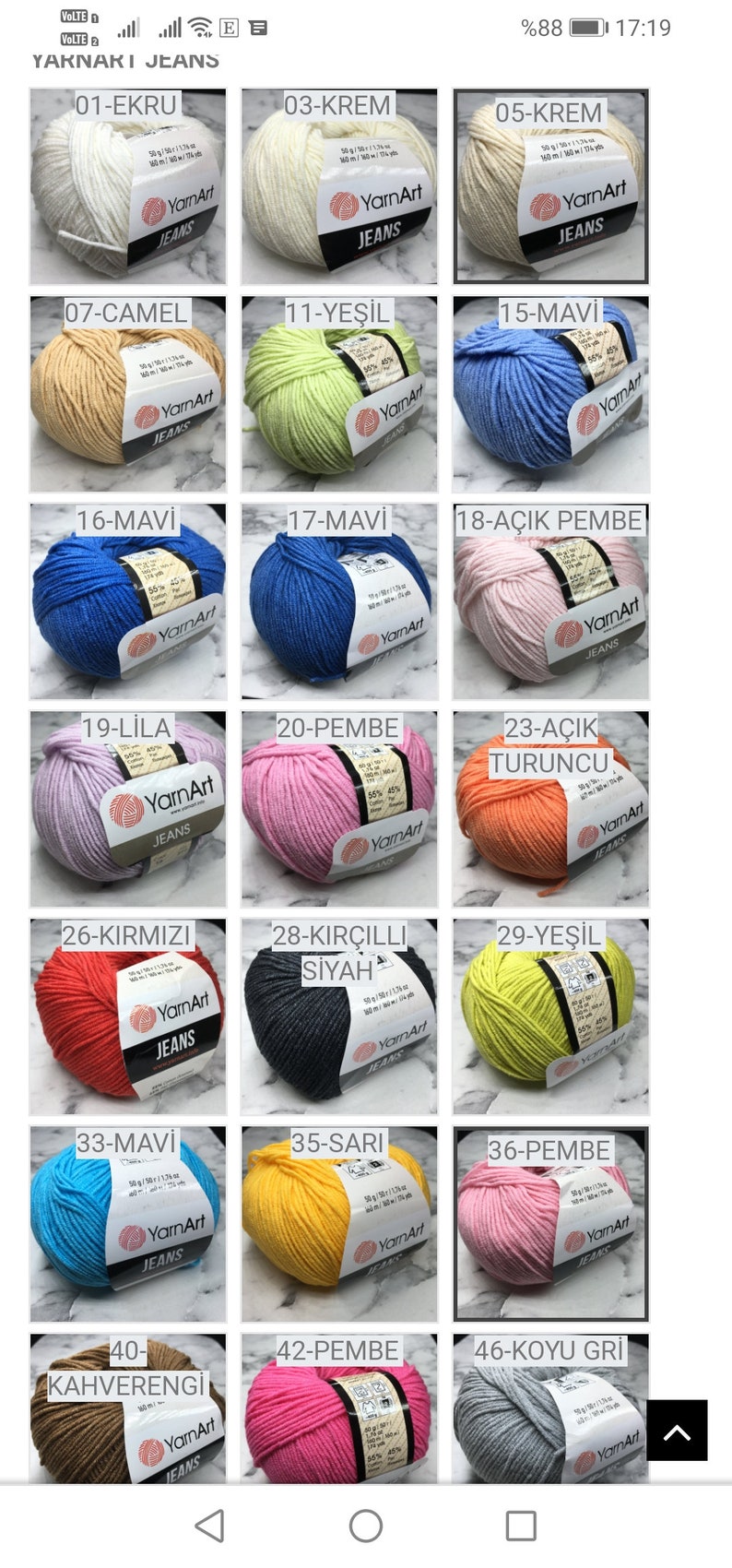 May include: A collection of yarn balls in various colours, including white, cream, light blue, light pink, yellow, orange, red, brown, grey, and green. Each ball has a label with the yarn brand name "YarnArt" and a number and colour name in Turkish.