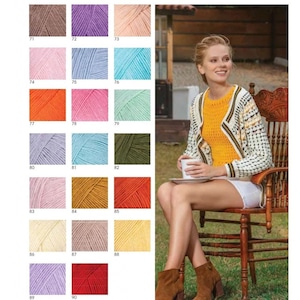 May include: A color chart of yarn samples in various colors, including brown, purple, pink, blue, orange, green, yellow, and red. The yarn samples are arranged in rows and columns, with each sample labeled with a number. A woman is sitting in a chair, wearing a crocheted cardigan in a white and black pattern, a yellow tank top, and a white skirt. She is holding a cup of coffee.