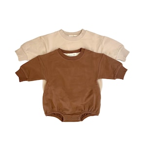 May include: A white ceramic mug with a black handle and the text "But First, Coffee" in a black, bold font. The mug is on a white surface. The mug is approximately 4 inches tall.