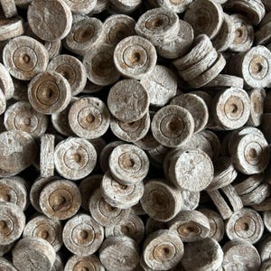 May include: A set of three ceramic mugs with a speckled, matte finish. The mugs are in shades of cream, light gray, and dark gray. Each mug has a simple, minimalist design, perfect for coffee or tea.