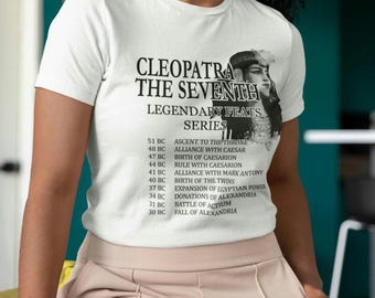 Puede incluir: Camiseta blanca con una imagen en blanco y negro de Cleopatra, la Séptima, con el texto "CLEOPATRA THE SEVENTH LEGENDARY FEATS SERIES" y una lista de sus logros desde el 51 a. C. hasta el 30 a. C.